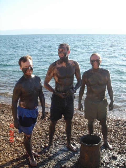 Supposedly the Dead Sea mud is good for your skin.  Or maybe they just like seeing tourists making fools of themselves..