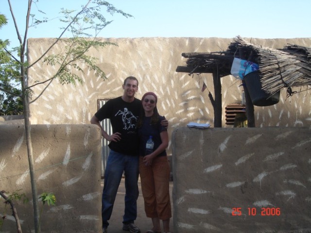 Elizabeth and I pose in front of her house.  After a couple of great days in Elizabeth's village, we were ready to head back to town on our newly fixed motorbikes. We were off to tour the countryside!