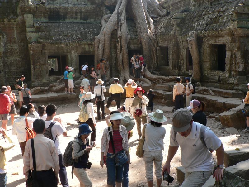 This part of the Ta Prohm temple was used in the filming of Tomb Raider and is now a constant mob site.  :-)  I'd rather take a picture of the craziness than elbow in to get my own "perfect" picture.