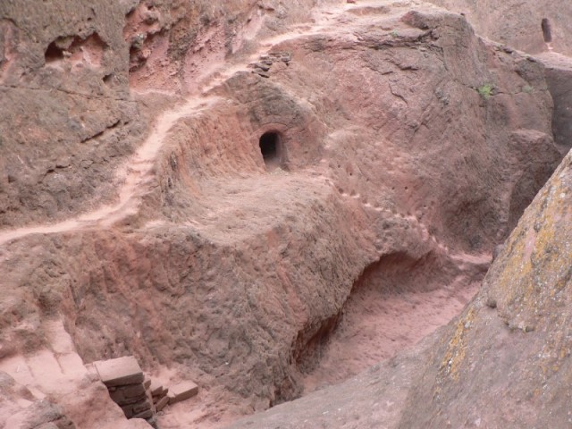 Some monks still live in tiny tomb-like holes cut into the side of the rock.