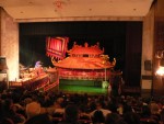 We went to see a water puppet show.  Eleven puppeteers stand behind a screen and make various puppets dance with long poles under the dark water.