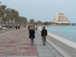 June and Jason walk along the Corniche.