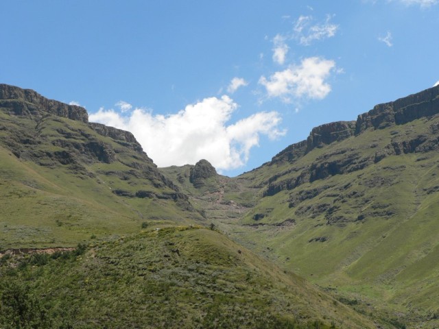 In the background here you can see the switchback road that winds up the side of the mountain.  This is the famous Sani Pass, where we are now headed.