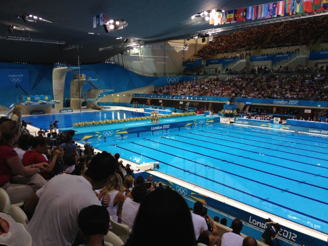 I had two tickets to see the Synchronized Swimming event but I was making the trip alone and didn't know anyone in the city yet. I approached one of the many volunteers outside the stadium and told him of my dilemma.