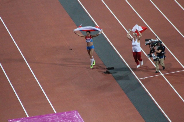 Tatyana and Anita W&#322;odarczyk of Poland celebrate their respective gold and silver medals.