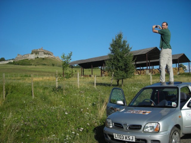 From Hungary we tried to cross into the Ukraine. We were at the border for 4 hours trying to explain that our temporary paperwork was legitimate, to no avail. Towards the end the border guard pulled me aside and said that I could pass for a "refundable" fee of $4,000. We opted to try another border instead. Here I am in the Romanian countryside trying again to get the perfect picture.